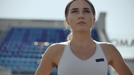 A-time-lapse-portrait-of-beautiful-woman-running-on-the-stadium-bleachers-with-concentrated-deep-breathing-and-motivating-myself-and-consciousness-for-the-race.-Discard-unnecessary-emotions-and-tune-in-to-win-preparing-for-the-race